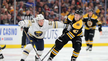Dec 27, 2019; Buffalo, New York, USA; Boston Bruins center Danton Heinen (43) shoots the puck as Buffalo Sabres left wing Jeff Skinner (53) defends during the third period at KeyBank Center. Mandatory Credit: Timothy T. Ludwig-USA TODAY Sports