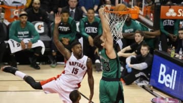 Mar 28, 2014; Toronto, Ontario, CAN; Boston Celtics forward Kris Humphries (43) dunks as Toronto Raptors forward Amir Johnson (15) attempts to defend at Air Canada Centre. The Raptors beat the Celtics 105-103. Mandatory Credit: Tom Szczerbowski-USA TODAY Sports