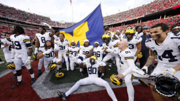 Nov 26, 2022; Columbus, Ohio, USA; Michigan Wolverines players plant the flag on the Ohio State Buckeyes fifty yard line following the win at Ohio Stadium. Mandatory Credit: Joseph Maiorana-USA TODAY Sports