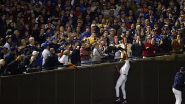 UNITED STATES - OCTOBER 14: Baseball: NLCS Playoffs, Chicago Cubs Moises Alou (18) in action, attempting foul ball catch foul vs Florida Marlins, Cubs fan Steve Bartman (blue cap) reaching and blocking ball during 8th inning of Game 6, Chicago, IL 10/14/2003 (Photo by John Biever/Sports Illustrated/Getty Images) (SetNumber: X69459 TK6)