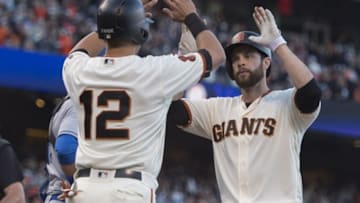 Jun 12, 2016; San Francisco, CA, USA; San Francisco Giants first baseman Brandon Belt (9) is congratulated at home plate by second baseman Joe Panik (12) after Belt hit a two-run home run during the sixth inning against the Los Angeles Dodgers to put the Giants ahead, 2-0 at AT&T Park. Mandatory Credit: Kenny Karst-USA TODAY Sports