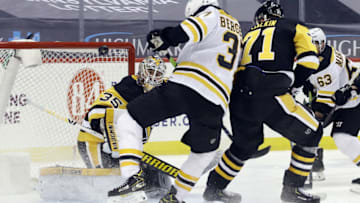Mar 15, 2021; Pittsburgh, Pennsylvania, USA; Pittsburgh Penguins goaltender Tristan Jarry (35) makes a save as Boston Bruins center Patrice Bergeron (37) is defended by Pens center Evgeni Malkin (71) during the third period at PPG Paints Arena. Pittsburgh won 4-1 Mandatory Credit: Charles LeClaire-USA TODAY Sports