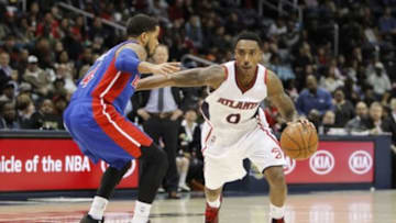 Nov 21, 2014; Atlanta, GA, USA; Atlanta Hawks guard Jeff Teague (0) drives past Detroit Pistons guard D.J. Augustin (14) in the fourth quarter at Philips Arena. The Hawks defeated the Pistons 99-89. Mandatory Credit: Brett Davis-USA TODAY Sports