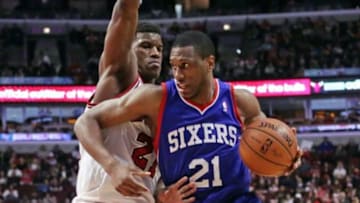 Mar 22, 2014; Chicago, IL, USA; Philadelphia 76ers forward Thaddeus Young (21) drives around Chicago Bulls guard Jimmy Butler (21) during the second quarter at the United Center. Mandatory Credit: Dennis Wierzbicki-USA TODAY Sports