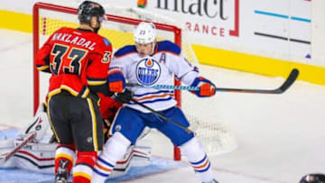 Sep 21, 2015; Calgary, Alberta, CAN; Edmonton Oilers center Matt Hendricks (23) and Calgary Flames defenseman Jakub Nakladal (33) fight for position in front of Calgary Flames goalie Joni Ortio (37) during the third period at Scotiabank Saddledome. Edmonton Oilers won 3-1. Mandatory Credit: Sergei Belski-USA TODAY Sports
