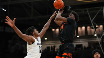 Feb 5, 2022; Boulder, Colorado, USA; Oregon State Beavers forward Ahmad Rand (44) shoots over Colorado Buffaloes forward Jabari Walker (12) in the second half at the CU Events Center. Mandatory Credit: Ron Chenoy-USA TODAY Sports