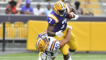 Apr 16, 2016; Baton Rouge, LA, USA; LSU Tigers running back Leonard Fournette (7) breaks the tackle of linebacker Duke Riley (40) during the first quarter of the Spring Game at Tiger Stadium. Mandatory Credit: Matt Bush-USA TODAY Sports