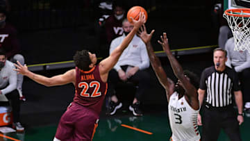 Feb 6, 2021; Coral Gables, Florida, USA; Virginia Tech Hokies forward Keve Aluma (22) rebounds the ball over Miami Hurricanes center Nysier Brooks (3) during the first half at Watsco Center. Mandatory Credit: Jasen Vinlove-USA TODAY Sports