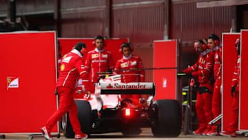 MONTMELO, SPAIN - MARCH 01: Members of the Ferrari team pull screens across the back of the car as Sebastian Vettel of Germany drives the (5) Scuderia Ferrari SF70H back to the garage during day three of Formula One winter testing at Circuit de Catalunya on March 1, 2017 in Montmelo, Spain. (Photo by Dan Istitene/Getty Images)