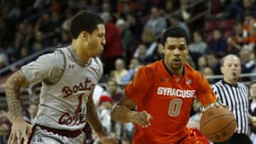 Feb 11, 2015; Chestnut Hill, MA, USA; Syracuse Orange guard Michael Gbinije (0) drives to the hoop against Boston College Eagles guard Dimitri Batten (1) during the second half at Silvio O. Conte Forum. Mandatory Credit: Mark L. Baer-USA TODAY Sports
