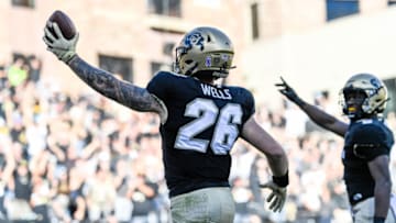 BOULDER, CO - OCTOBER 16: Linebacker Carson Wells #26 of the Colorado Buffaloes returns an interception for a touchdown in the third quarter of a game against the Arizona Wildcats at Folsom Field on October 16, 2021 in Boulder, Colorado. (Photo by Dustin Bradford/Getty Images)