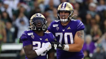 SEATTLE, WASHINGTON - SEPTEMBER 14: Richard Newton #28 celebrates with Jared Hilbers #70 of the Washington Huskies after scoring a one yard touchdown against the Hawaii Rainbow Warriors in the fourth quarter during their game at Husky Stadium on September 14, 2019 in Seattle, Washington. (Photo by Abbie Parr/Getty Images)
