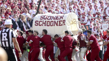 Oct 19, 2019; Norman, OK, USA; Oklahoma Sooners rufneks and cheerleaders help take the Sooner Schooner off the field after it fell over during the second quarter against the West Virginia Mountaineers at Gaylord Family - Oklahoma Memorial Stadium. Mandatory Credit: Kevin Jairaj-USA TODAY Sports