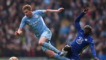 TOPSHOT - Manchester City's Belgian midfielder Kevin De Bruyne (L) avoids a challenge by Chelsea's French midfielder N'Golo Kante during the English Premier League football match between Manchester City and Chelsea at the Etihad Stadium in Manchester, north west England, on January 15, 2022. - RESTRICTED TO EDITORIAL USE. No use with unauthorized audio, video, data, fixture lists, club/league logos or 'live' services. Online in-match use limited to 120 images. An additional 40 images may be used in extra time. No video emulation. Social media in-match use limited to 120 images. An additional 40 images may be used in extra time. No use in betting publications, games or single club/league/player publications. (Photo by Oli SCARFF / AFP) / RESTRICTED TO EDITORIAL USE. No use with unauthorized audio, video, data, fixture lists, club/league logos or 'live' services. Online in-match use limited to 120 images. An additional 40 images may be used in extra time. No video emulation. Social media in-match use limited to 120 images. An additional 40 images may be used in extra time. No use in betting publications, games or single club/league/player publications. / RESTRICTED TO EDITORIAL USE. No use with unauthorized audio, video, data, fixture lists, club/league logos or 'live' services. Online in-match use limited to 120 images. An additional 40 images may be used in extra time. No video emulation. Social media in-match use limited to 120 images. An additional 40 images may be used in extra time. No use in betting publications, games or single club/league/player publications. (Photo by OLI SCARFF/AFP via Getty Images)