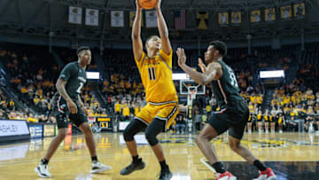 Wichita State Shockers forward Kenny Pohto fakes shots against Cincinnati Bearcats forward Ody Oguama at Charles Koch Arena. USA Today.