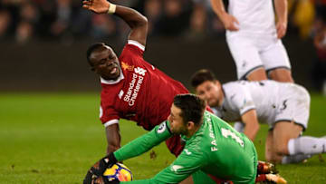 SWANSEA, WALES - JANUARY 22: Sadio Mane of Liverpool and Lukasz Fabianski of Swansea City clash during the Premier League match between Swansea City and Liverpool at Liberty Stadium on January 22, 2018 in Swansea, Wales. (Photo by Stu Forster/Getty Images)