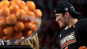 MIAMI GARDENS, FL - DECEMBER 30: Alex Hornibrook #12 of the Wisconsin Badgers celebrates after winning the MVP trophy of the 2017 Capital One Orange Bowl against the Miami Hurricanes against the Miami Hurricanes at Hard Rock Stadium on December 30, 2017 in Miami Gardens, Florida. (Photo by Mike Ehrmann/Getty Images)