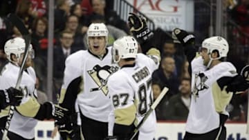 Mar 6, 2016; Newark, NJ, USA; Pittsburgh Penguins center Evgeni Malkin (71) celebrates with teammates after scoring a goal against the New Jersey Devils during the first period at Prudential Center. Mandatory Credit: Adam Hunger-USA TODAY Sports