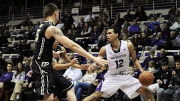 Feb 2, 2013; Evanston, IL, USA; Northwestern Wildcats forward Jared Swopshire (12) is defended by Purdue Boilermakers forward Donnie Hale (15) during the second half at Welsh-Ryan Arena. The Northwestern Wildcats defeated the Purdue Boilermakers 75-60. Mandatory Credit: David Banks-USA TODAY Sports