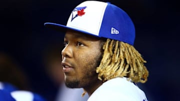 Vladimir Guerrero Jr. #27 of the Toronto Blue Jays looks on from the dugout on a night off in the first inning during a MLB game against the Minnesota Twins at Rogers Centre. (Photo by Vaughn Ridley/Getty Images)