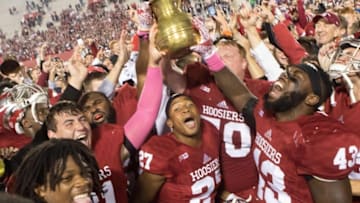 Oct 1, 2016; Bloomington, IN, USA; Indiana Hoosiers offensive lineman Jacob Bailey (70) and linebacker Dameon Willis Jr. (43) and other teammates hoist the brass spittoon in victory after the game against the Michigan State Spartans at Memorial Stadium. Indiana Hoosiers beat the Michigan State Spartans by the score of 24-21. Mandatory Credit: Trevor Ruszkowski-USA TODAY Sports