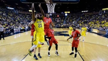 Mar 7, 2015; Ann Arbor, MI, USA; Michigan Wolverines guard/forward Zak Irvin (21) goes to the basket on Rutgers Scarlet Knights forward/center Kadeem Jack (11) at Crisler Center. Mandatory Credit: Rick Osentoski-USA TODAY Sports