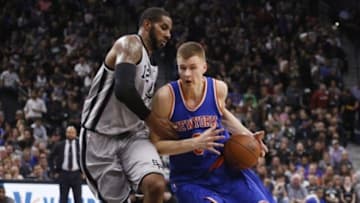 Jan 8, 2016; San Antonio, TX, USA; New York Knicks power forward Kristaps Porzingis (right) drives to the basket as San Antonio Spurs power forward LaMarcus Aldridge (12) defends during the second half at AT&T Center. Mandatory Credit: Soobum Im-USA TODAY Sports