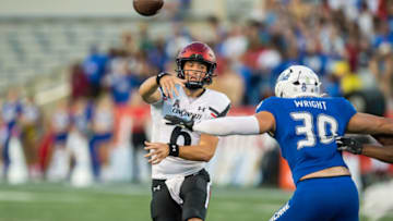 Cincinnati Bearcats quarterback Ben Bryant throws pass against Tulsa Golden Hurricane. USA Today.