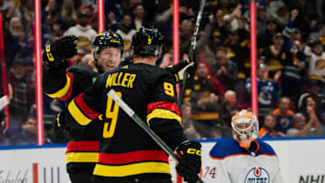 Nov 6, 2023; Vancouver, British Columbia, CAN; Edmonton Oilers goalie Stuart Skinner (74) watches as Vancouver Canucks forward Brock Boeser (6) and forward J.T. Miller (9) celebrate BoeserÕs goal in the first period at Rogers Arena. Mandatory Credit: Bob Frid-USA TODAY Sports
