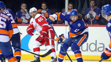 Feb 15, 2016; Brooklyn, NY, USA; New York Islanders left wing Matt Martin (17) passes the puck in front of Detroit Red Wings left wing Henrik Zetterberg (40) during the third period at Barclays Center. The Islanders defeated the Red Wings 4-1. Mandatory Credit: Brad Penner-USA TODAY Sports