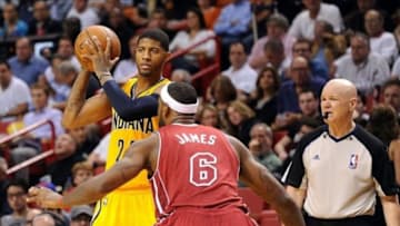 Dec 18, 2013; Miami, FL, USA; Indiana Pacers small forward Paul George (24) is pressured by Miami Heat small forward LeBron James (6) during the second half at American Airlines Arena. Miami won 97-94. Mandatory Credit: Steve Mitchell-USA TODAY Sports