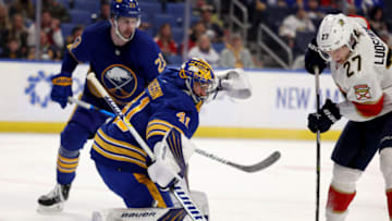 Mar 7, 2022; Buffalo, New York, USA; Florida Panthers center Eetu Luostarinen (27) tries to deflect a shot on Buffalo Sabres goaltender Craig Anderson (41) during the third period at KeyBank Center. Mandatory Credit: Timothy T. Ludwig-USA TODAY Sports