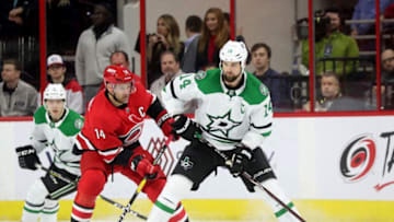 RALEIGH, NC - FEBRUARY 16: Justin Williams #14 of the Carolina Hurricanes defends against Jamie Benn #14 of the Dallas Stars during an NHL game on February 16, 2019 at PNC Arena in Raleigh, North Carolina. (Photo by Gregg Forwerck/NHLI via Getty Images)