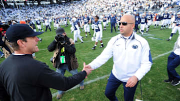 STATE COLLEGE, PA - NOVEMBER 21: James Franklin head coach of the Penn State Nittany Lions congratulates Jim Harbaugh head coach of the Michigan Wolverines after the game at Beaver Stadium on November 21, 2015 in State College, Pennsylvania. The Wolverines won 28-16. (Photo by Evan Habeeb/Getty Images)