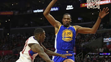 Dec 7, 2016; Los Angeles, CA, USA; LA Clippers guard Jamal Crawford (11) passes under the basket against Golden State Warriors forward Kevin Durant (35) in the third quarter at Staples Center. Mandatory Credit: Richard Mackson-USA TODAY Sports