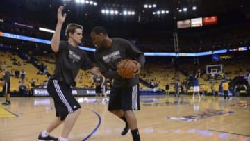 May 10, 2013; Oakland, CA, USA; San Antonio Spurs assistant coach Chad Forcier (left) defends against shooting guard Tracy McGrady (1, right) during warm ups before game three of the second round of the 2013 NBA Playoffs against the Golden State Warriors at Oracle Arena. Mandatory Credit: Kyle Terada-USA TODAY Sports