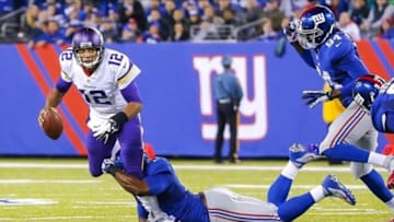 Oct 21, 2013; East Rutherford, NJ, USA; New York Giants defensive end Justin Tuck (91) sacks Minnesota Vikings quarterback Josh Freeman (12) during the second half at MetLife Stadium. New York Giants defeat the Minnesota Vikings 23-7. Mandatory Credit: Jim O