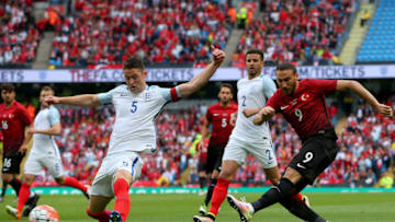 MANCHESTER, ENGLAND - MAY 22: Cenk Tosun of Turkey shoots at goal under prelssure from Gary Cahill of England uring the International Friendly match between England and Turkey at Etihad Stadium on May 22, 2016 in Manchester, England. (Photo by Alex Livesey/Getty Images)