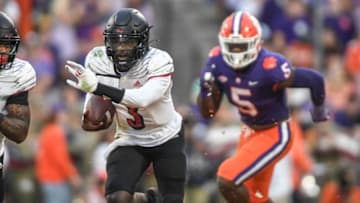 Nov 12, 2022; Clemson, South Carolina, USA;Louisville quarterback Malik Cunningham (3) runs by Clemson defensive end K.J. Henry (5) during the second quarter at Memorial Stadium in Clemson, South Carolina Saturday, Nov. 12, 2022. Mandatory Credit: Ken Ruinard-USA TODAY Sports