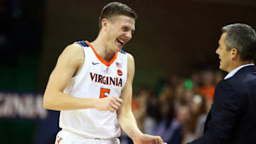 CHARLOTTESVILLE, VA - DECEMBER 03: Kyle Guy #5 of the Virginia Cavaliers smiles as he returns to the bench and greets coach Tony Bennett in the first half during a game against the Morgan State Bears at John Paul Jones Arena on December 3, 2018 in Charlottesville, Virginia. (Photo by Ryan M. Kelly/Getty Images)