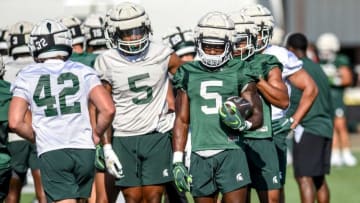 Michigan State running back Nathan Carter holds the ball during a drill during the opening day of MSU's football fall camp on Thursday, Aug. 3, 2023, in East Lansing.
