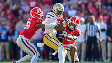 Georgia Tech Yellow Jackets quarterback Taisun Phommachanh (17) is tackled by Georgia Bulldogs defensive backs Christopher Smith (29) and Tykee Smith (23) Mandatory Credit: Dale Zanine-USA TODAY Sports