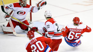 WASHINGTON, DC - DECEMBER 27: Carolina Hurricanes goaltender Petr Mrazek (34) makes a third period save on a shot by Washington Capitals left wing Andre Burakovsky (65) on December 27, 2018, at the Capital One Arena in Washington, D.C. (Photo by Mark Goldman/Icon Sportswire via Getty Images)