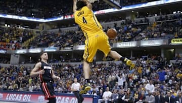 Apr 5, 2015; Indianapolis, IN, USA; Indiana Pacers forward Luis Scola (4) dunks against Miami Heat guard Tyler Johnson (8) at Bankers Life Fieldhouse. Indiana defeats Miami 112-89. Mandatory Credit: Brian Spurlock-USA TODAY Sports
