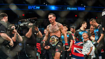 Jul 27, 2019; Edmonton, Alberta, Canada; Max Holloway (red gloves) defeats Frankie Edgar (blue gloves) during UFC 240 at Rogers Place. Mandatory Credit: Sergei Belski-USA TODAY Sports