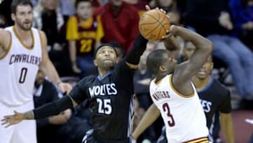 Dec 23, 2014; Cleveland, OH, USA; Minnesota Timberwolves guard Mo Williams (25) blocks a shot by Cleveland Cavaliers guard Dion Waiters (3) in the fourth quarter at Quicken Loans Arena. Mandatory Credit: David Richard-USA TODAY Sports