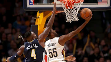 DENVER, CO - NOVEMBER 17: E'Twuan Moore #55 of the New Orleans Pelicans drives to the basket against Paul Millsap #4 of the Denver Nuggets at the Pepsi Center on November 17, 2017 in Denver, Colorado. NOTE TO USER: User expressly acknowledges and agrees that, by downloading and or using this photograph, User is consenting to the terms and conditions of the Getty Images License Agreement. (Photo by Matthew Stockman/Getty Images)