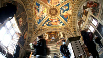 VATICAN CITY, VATICAN - FEBRUARY 04: (EDITORIAL NEWS USE ONLY – STRICTLY NO COMMERCIAL OR MERCHANDISING USAGE) Visitors observe the Raphael Rooms frescos at the Vatican Museums on February 04, 2021 in Vatican City, Vatican. Beginning on Monday, 1 February 2021, the Vatican Museums are open again to visitors, making it possible to visit the Sistine Chapel, the Raphael Rooms, and all the other masterpieces of art, history, and faith in the Pope’s collections. The Museums will be open Monday through Saturday, with online reservations required. (Photo by Franco Origlia/Getty Images)