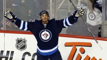 Apr 10, 2014; Winnipeg, Manitoba, CAN; Winnipeg Jets forward Evander Kane (9) celebrates his goal on Boston Bruins goalie Chad Johnson (30) (not shown) during the third period at MTS Centre. Winnipeg wins 2-1 overtime. Mandatory Credit: Bruce Fedyck-USA TODAY Sports