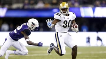 Nov 8, 2014; Seattle, WA, USA; UCLA Bruins running back Myles Jack (30) rushes for a 28-yard touchdown against the Washington Huskies during the second quarter at Husky Stadium. Mandatory Credit: Joe Nicholson-USA TODAY Sports